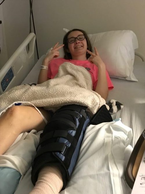 Cori Fischer in hospital after leg surgery from movement disorder