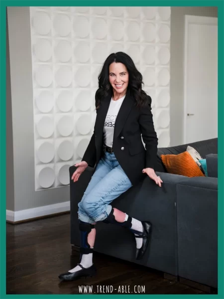 Woman wearing leg braces styled with modern outfit, smiling confidently, representing life and style with disability