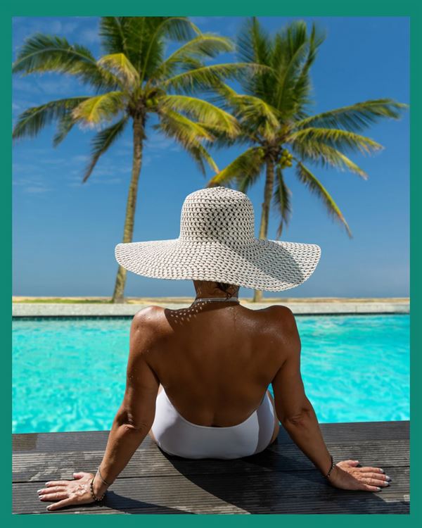 Poolside resort moment with woman enjoying the water.